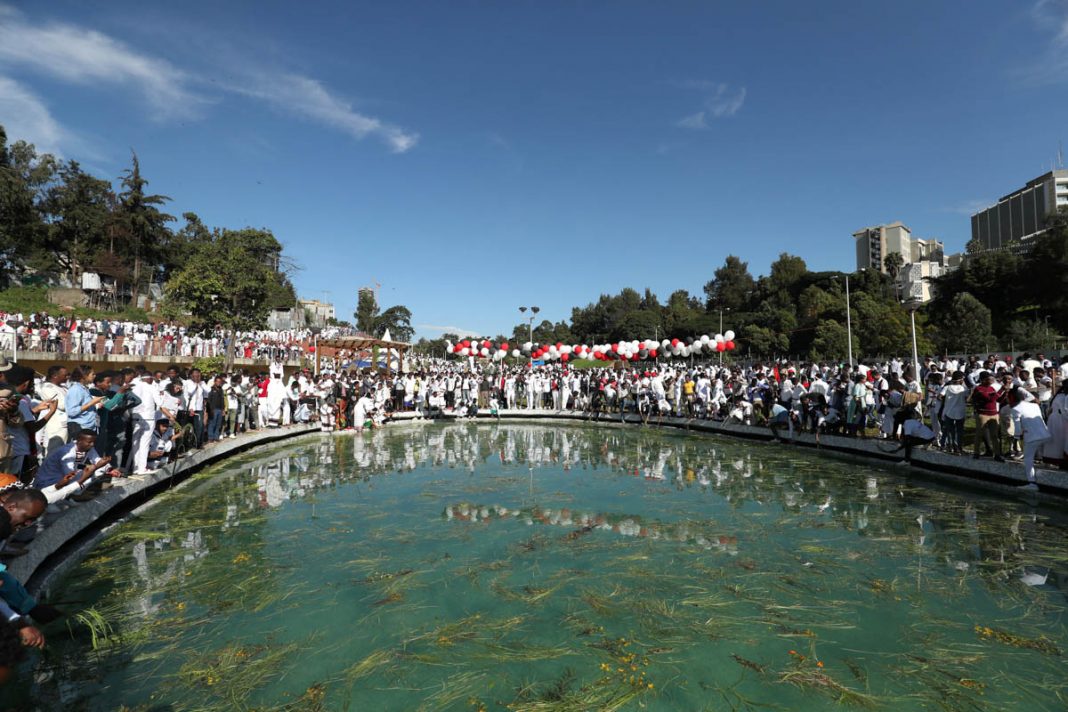 People sprinkle water on their body as they take part in the Irreecha celebration, the Oromo People thanksgiving ceremony in Addis Ababa
